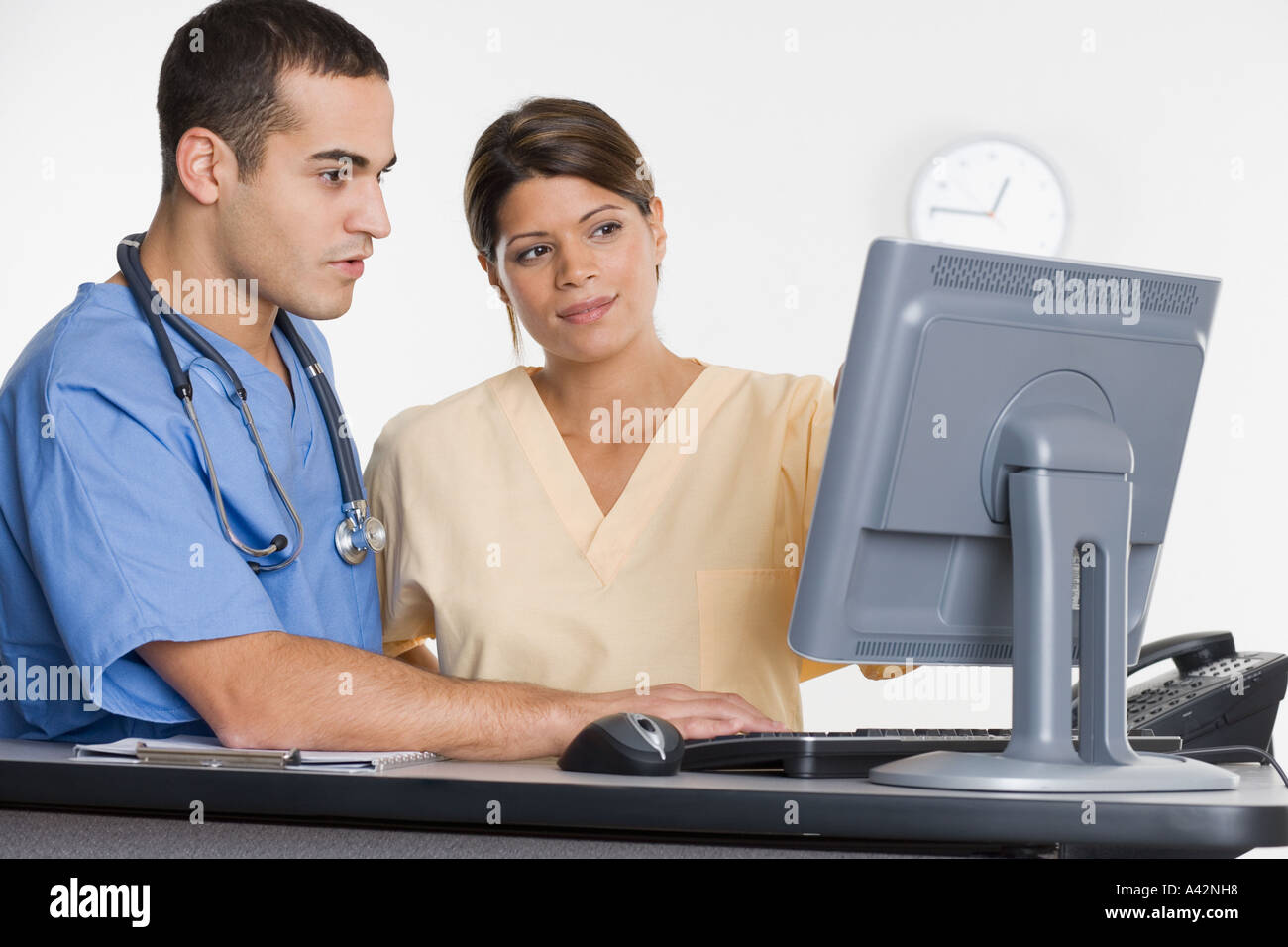 Nurses looking at computer monitor Stock Photo