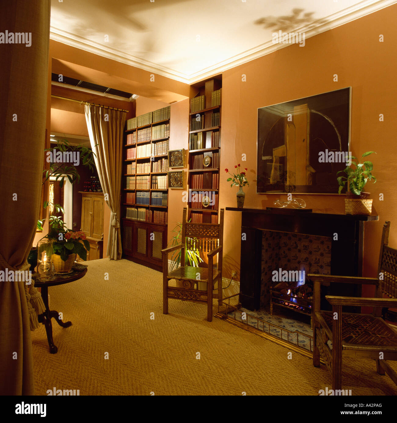 Terracotta hall with fireplace and sisal carpet Stock Photo - Alamy