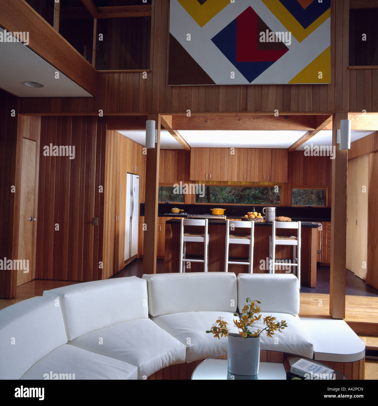 Curved white sofa in modern openplan living and dining room Stock Photo ...