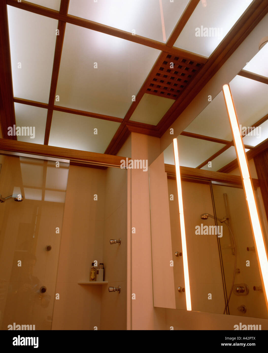 Lighted glass panels in ceiling of modern bathroom with lighted mirror  Stock Photo - Alamy, image size:1056x1390