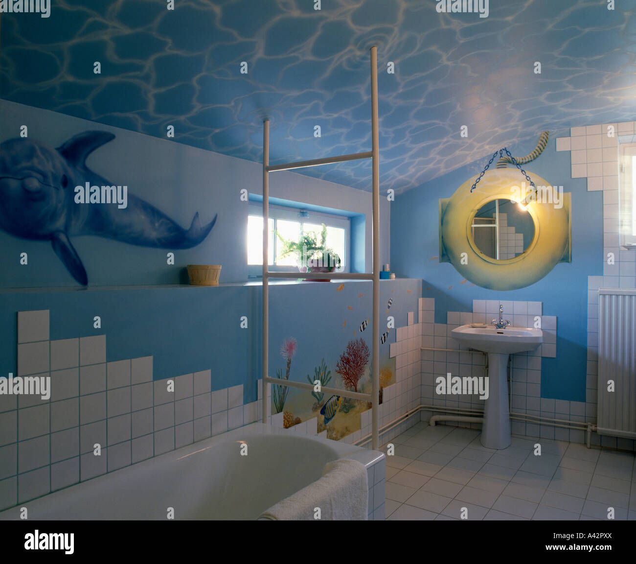 Blue Bathroom With Painted Seascape Mural On Walls And