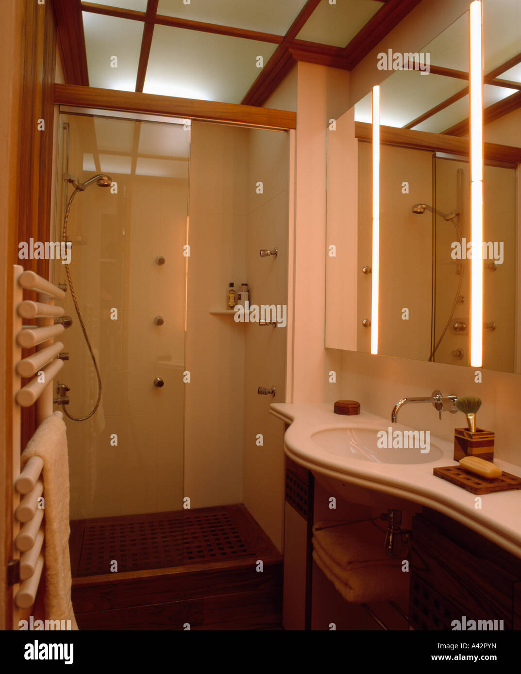 Modern Bathroom With Mirror Above Basin And Glass Panels In