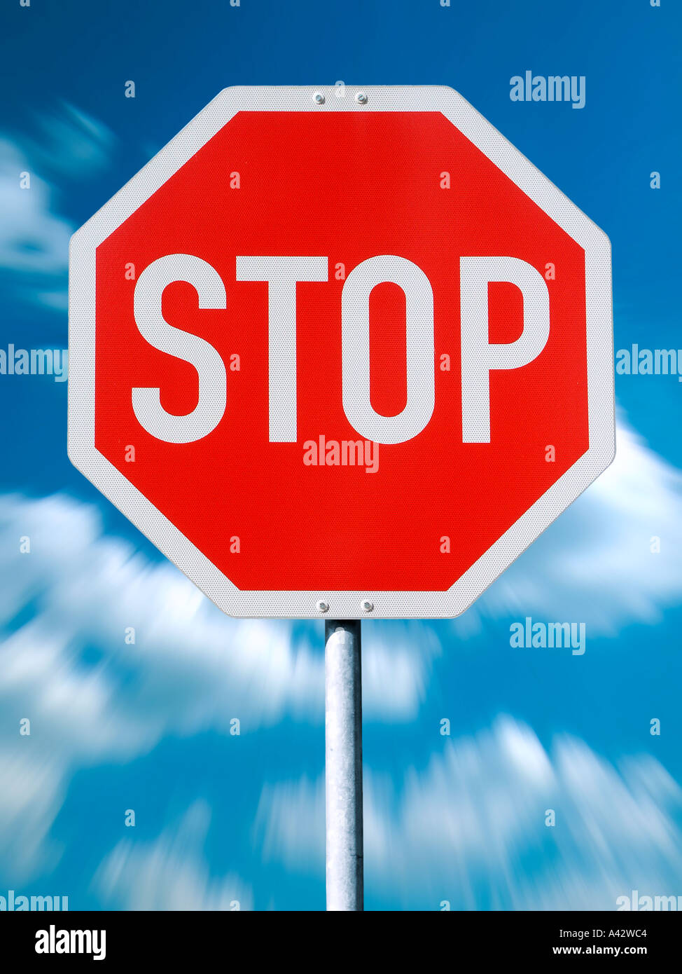 Stop sign before blue cloud sky Stopschild vor blauem Wolkenhimmel Stock Photo