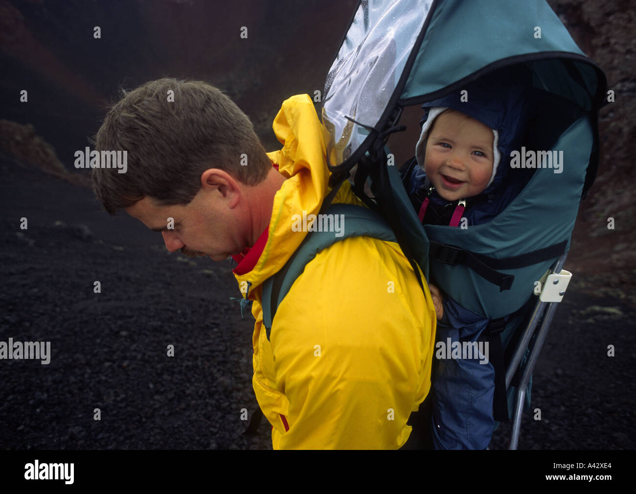 Father carrying son in backpack at Craters of the Moon National Monument Idaho Stock Photo