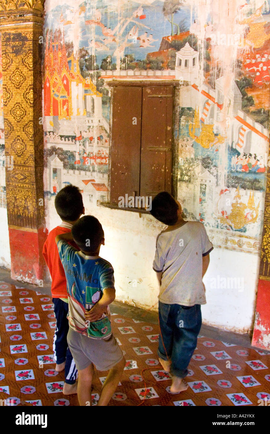 Children look at Wall Paintings Wat Long Khun Bon Xieng Maen Luang Prabang Laos Stock Photo