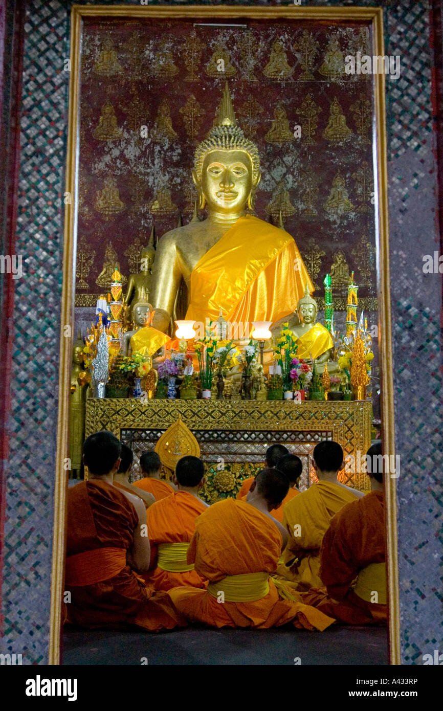 Monks and Novices at Prayer Wat Xieng Muan Luang Prabang Laos Stock Photo