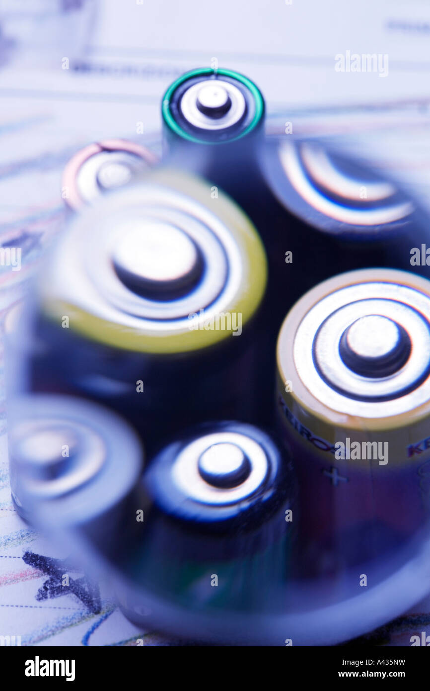 Magnifying glass over batteries Stock Photo Alamy