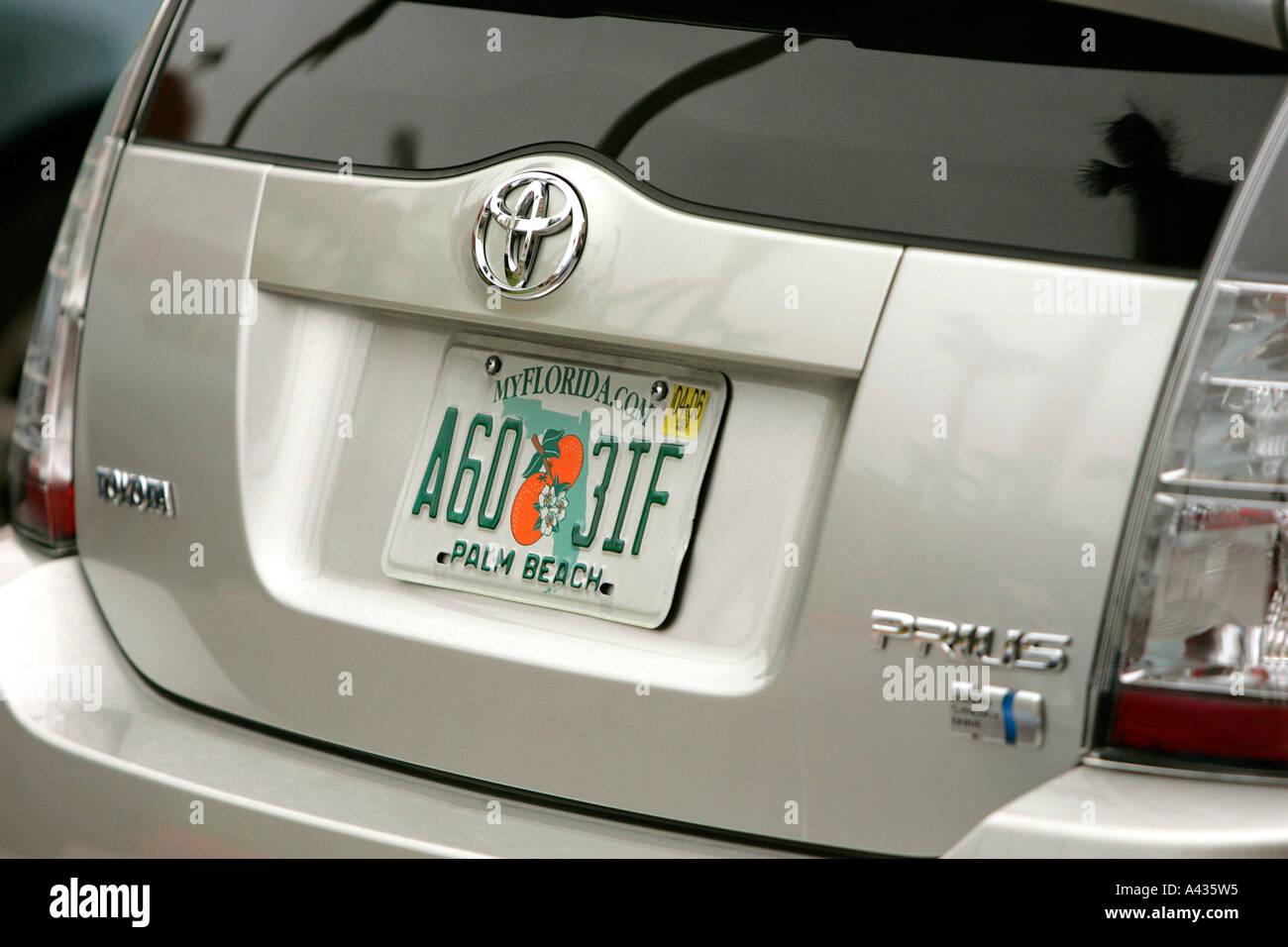 License plate orange white rectangle rectangular blue yellow red curve writing written lettering