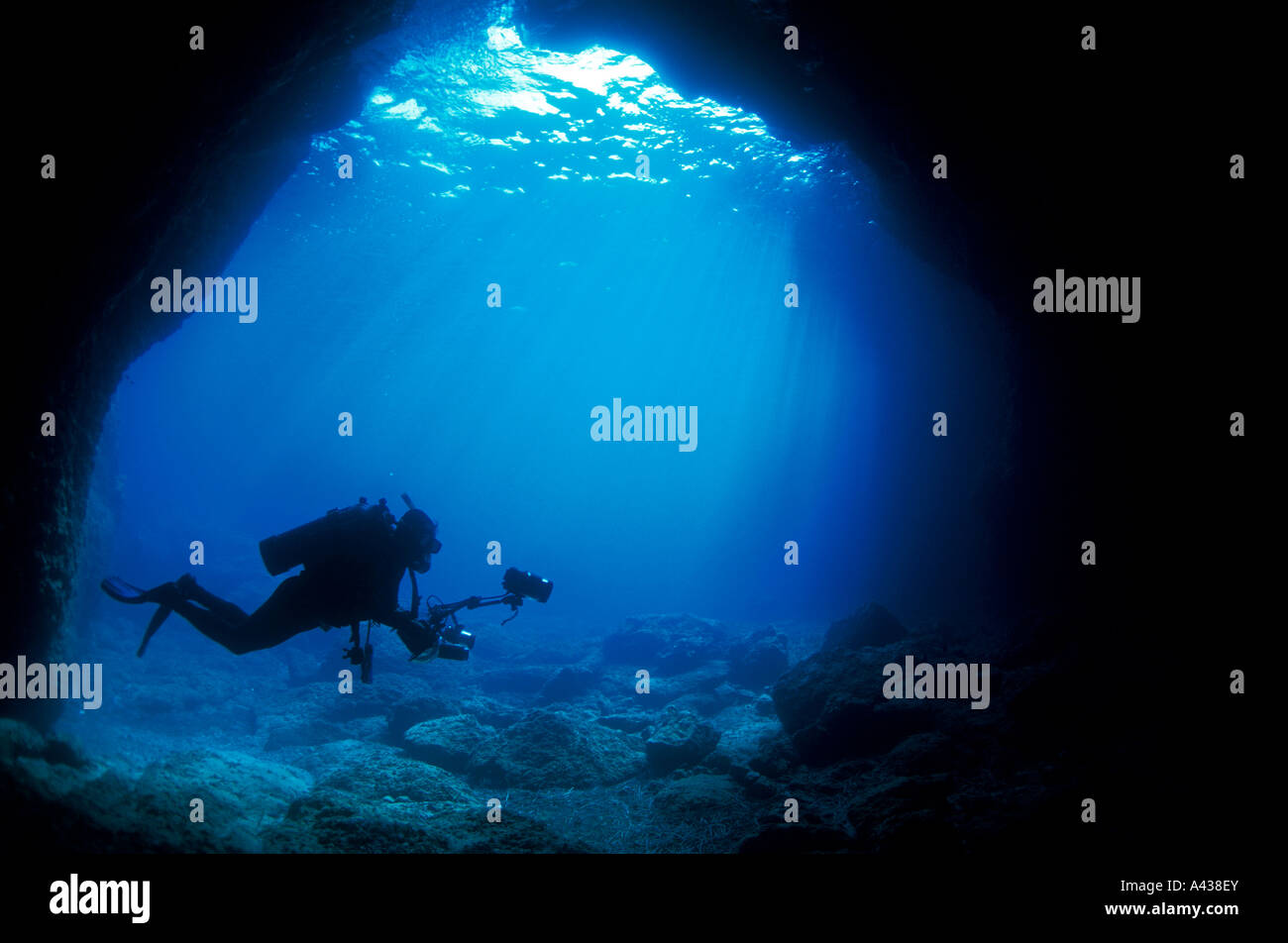 Underwater photographer at the entrance of a marine cave, Fethiye Turkey. Stock Photo