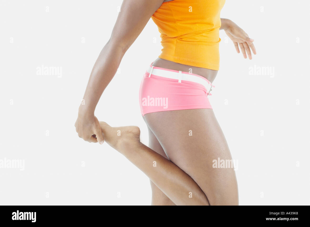 Mid section of woman stretching Stock Photo