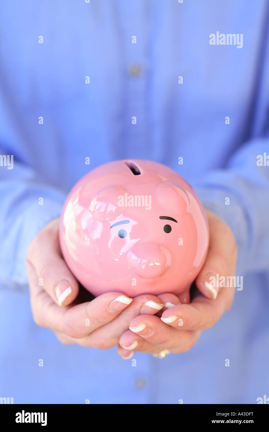 Hands Holding Piggy bank Stock Photo - Alamy