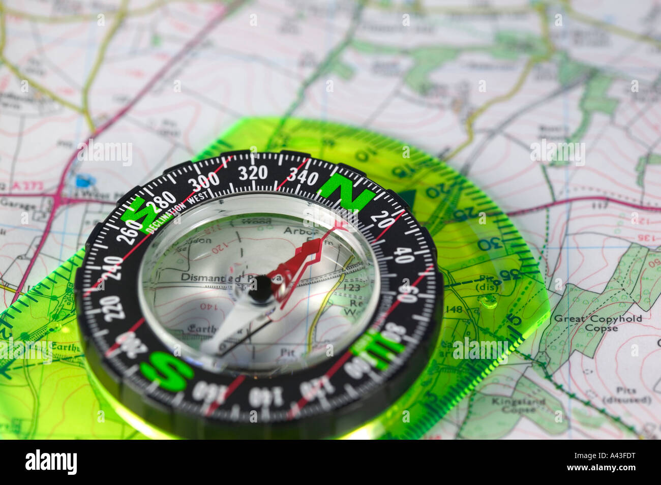An orienteering compass laid on a map Stock Photo