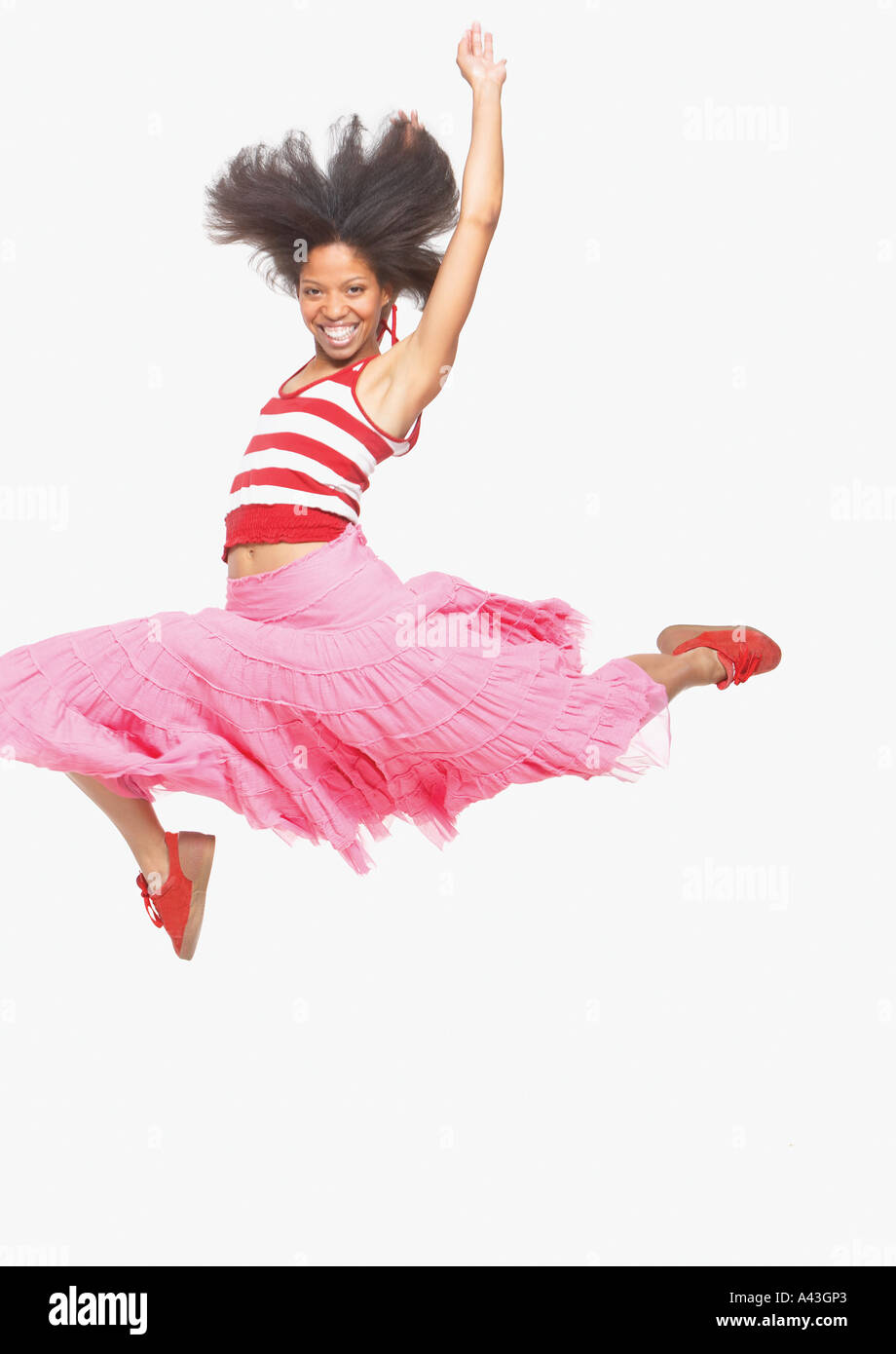 Full view portrait of woman in skirt jumping up Stock Photo Alamy
