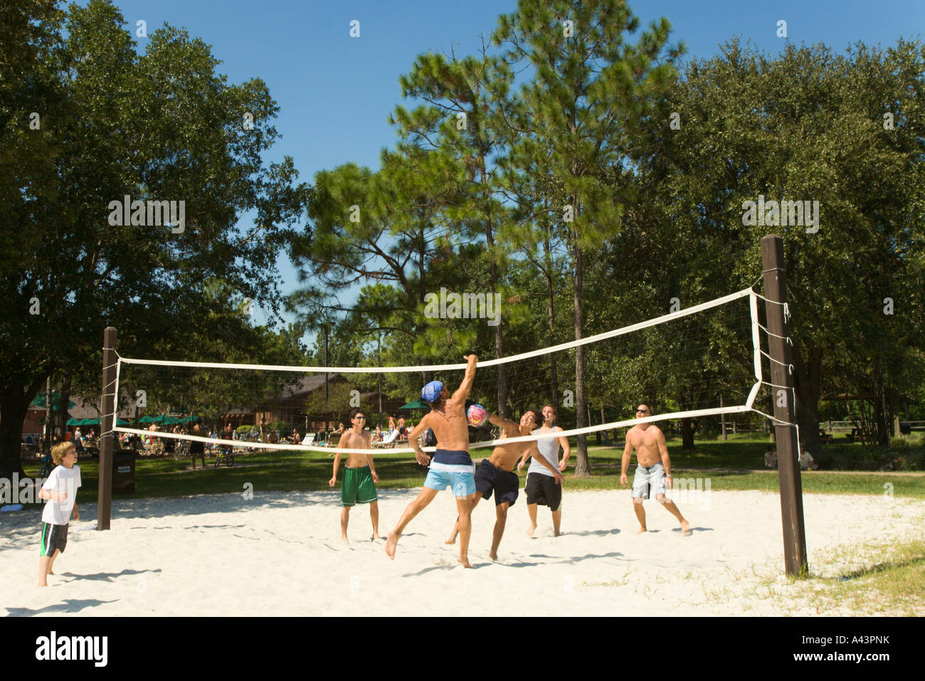Guests play beach sand volleyball organized activity at Fort Wilderness