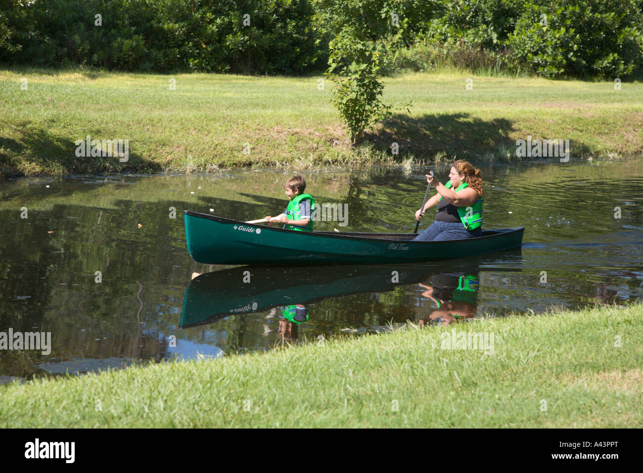 Mother and son canoeing in stream at Fort Wilderness Campground in Walt