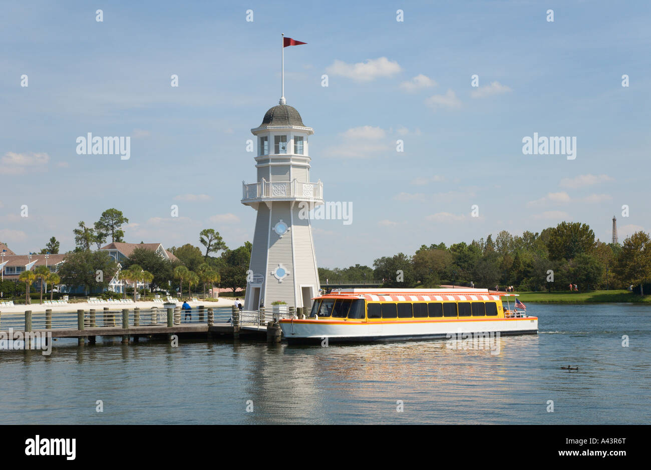 Shuttle boat loads passengers at lighthouse dock at Boardwalk in Walt Disney World, Florida, USA Stock Photo