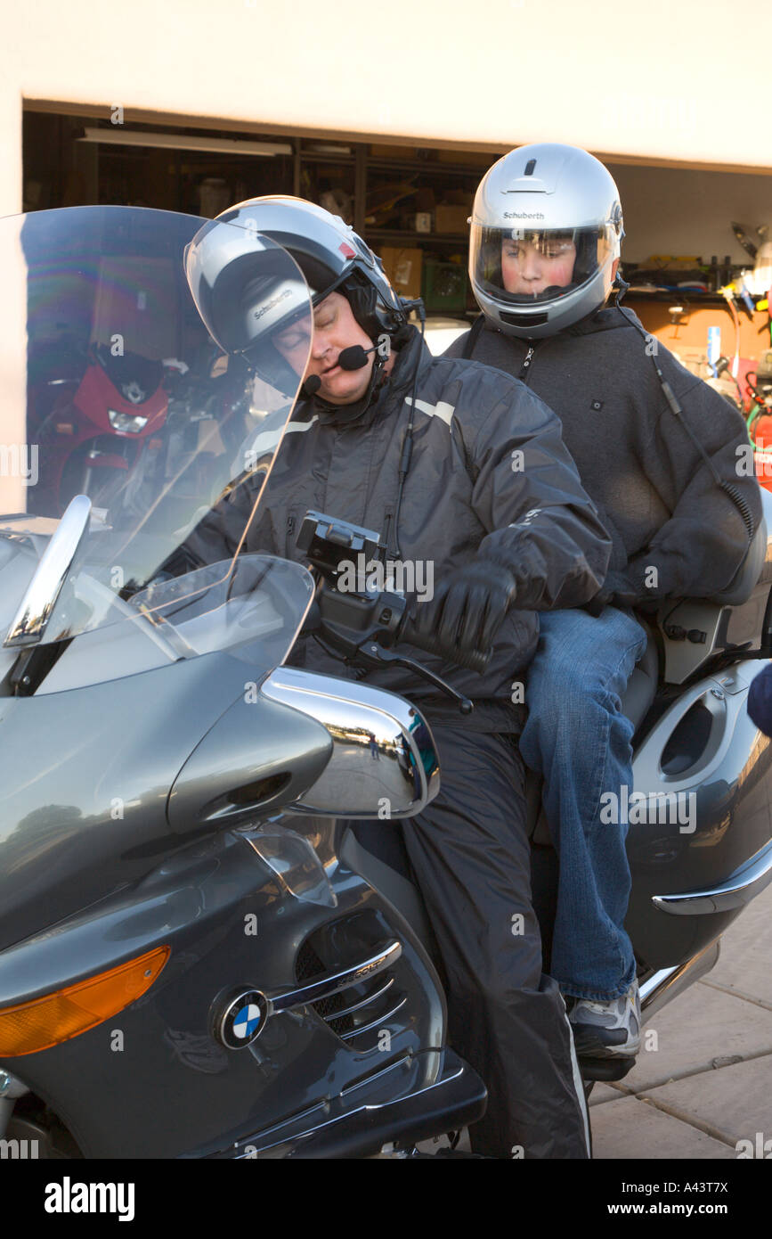 Man and Woman prepare for motorcycle ride in cool weather Stock Photo