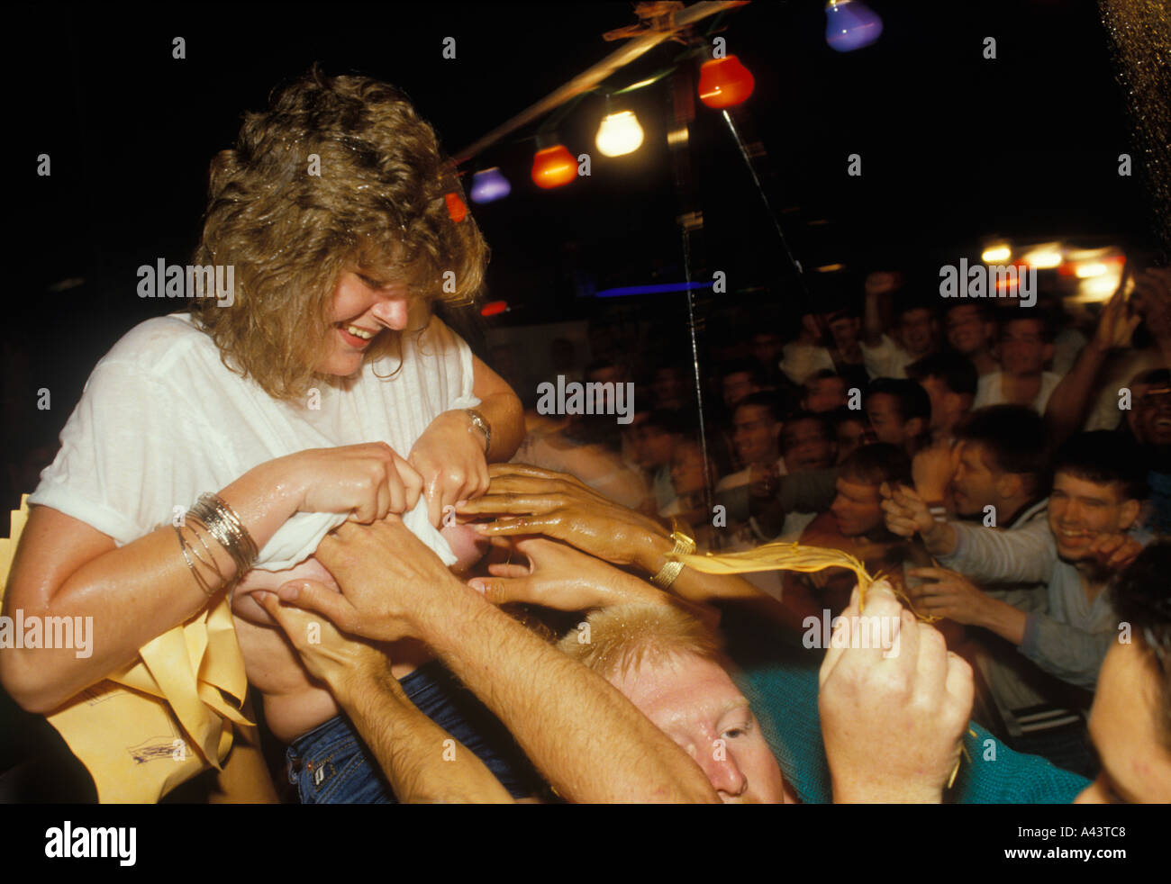 Wet T shirt competition men groping at a young woman 1980s UK HOMER SYKES  Stock Photo - Alamy