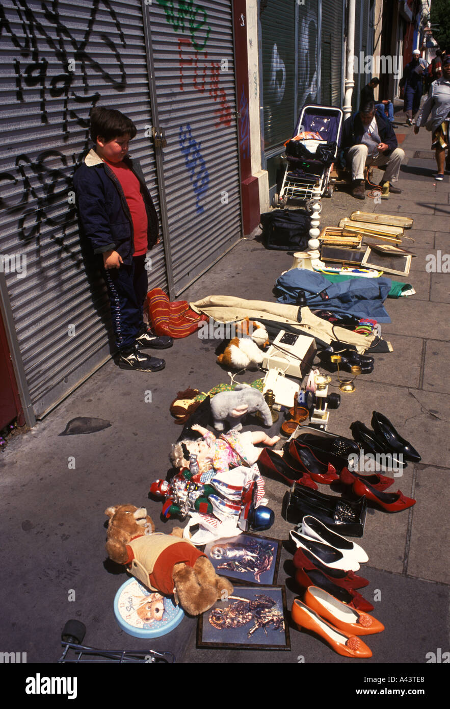 Childhood poverty 1990s,boy selling family unwanted stuff less fashionable poor northern end Portobello Road Notting Hill London UK 1999 HOMER SYKES Stock Photo