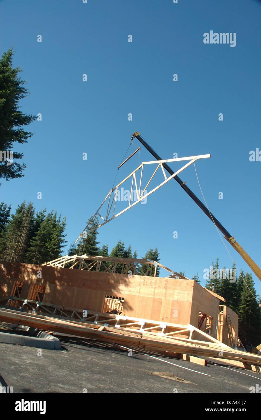 Construction View Shows Crane Lifting Wooden Roof Truss Stock Photo