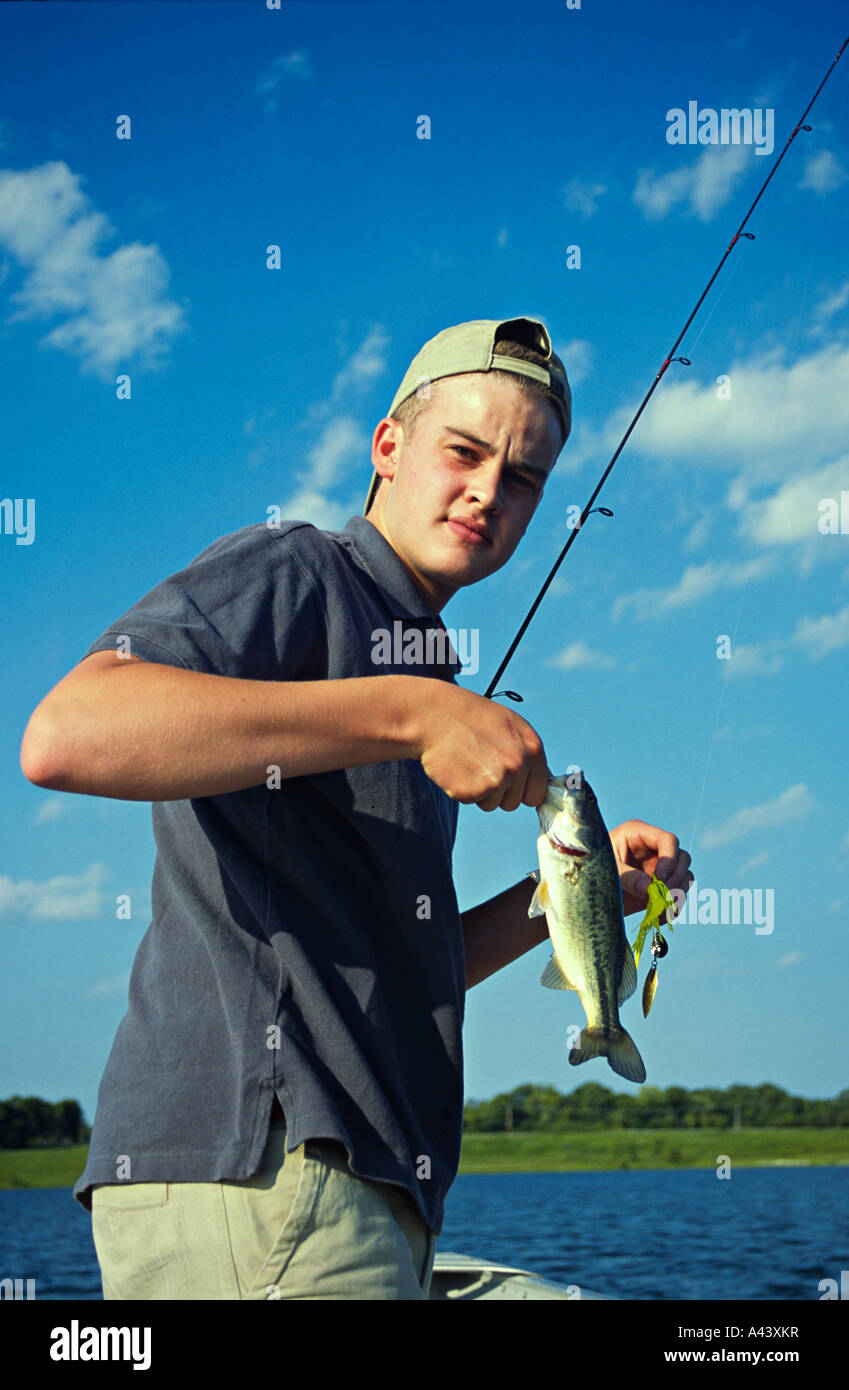 FISHING Libertyville Teenage boy hold bass fish and pole fishing