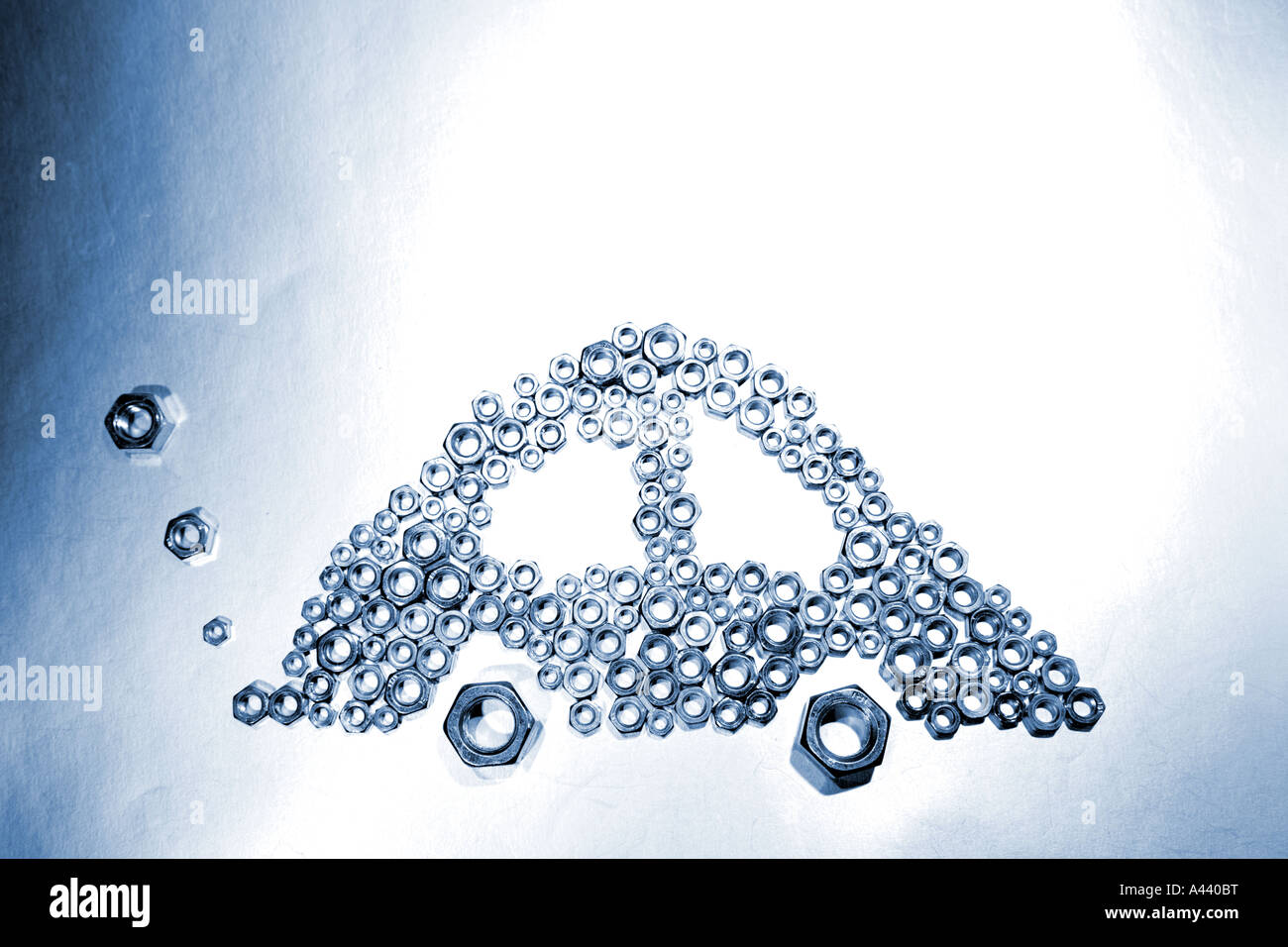 Car made from metal nuts with smoky exhaust Stock Photo