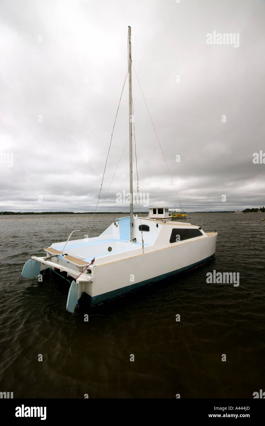 CATAMARRAN SAILING BOAT MOORED ON A CALM MORNING VERTICAL BAPDB4972 Stock Photo