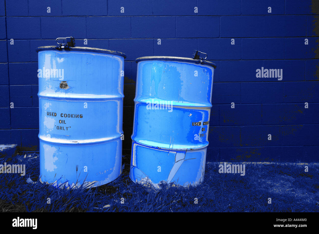 TWO FULL DRUMS OF COOKING OIL OUTSIDE A RESTAURANT AWAITING DISPOSAL