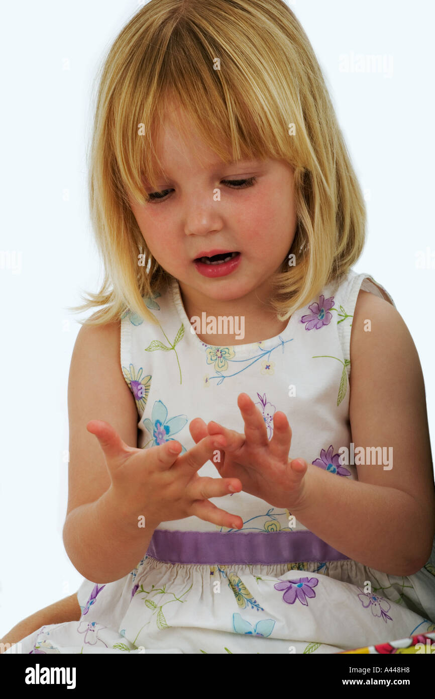 Child Portrait of a 3 Year old playing counting fingers  Studio shot Stock Photo