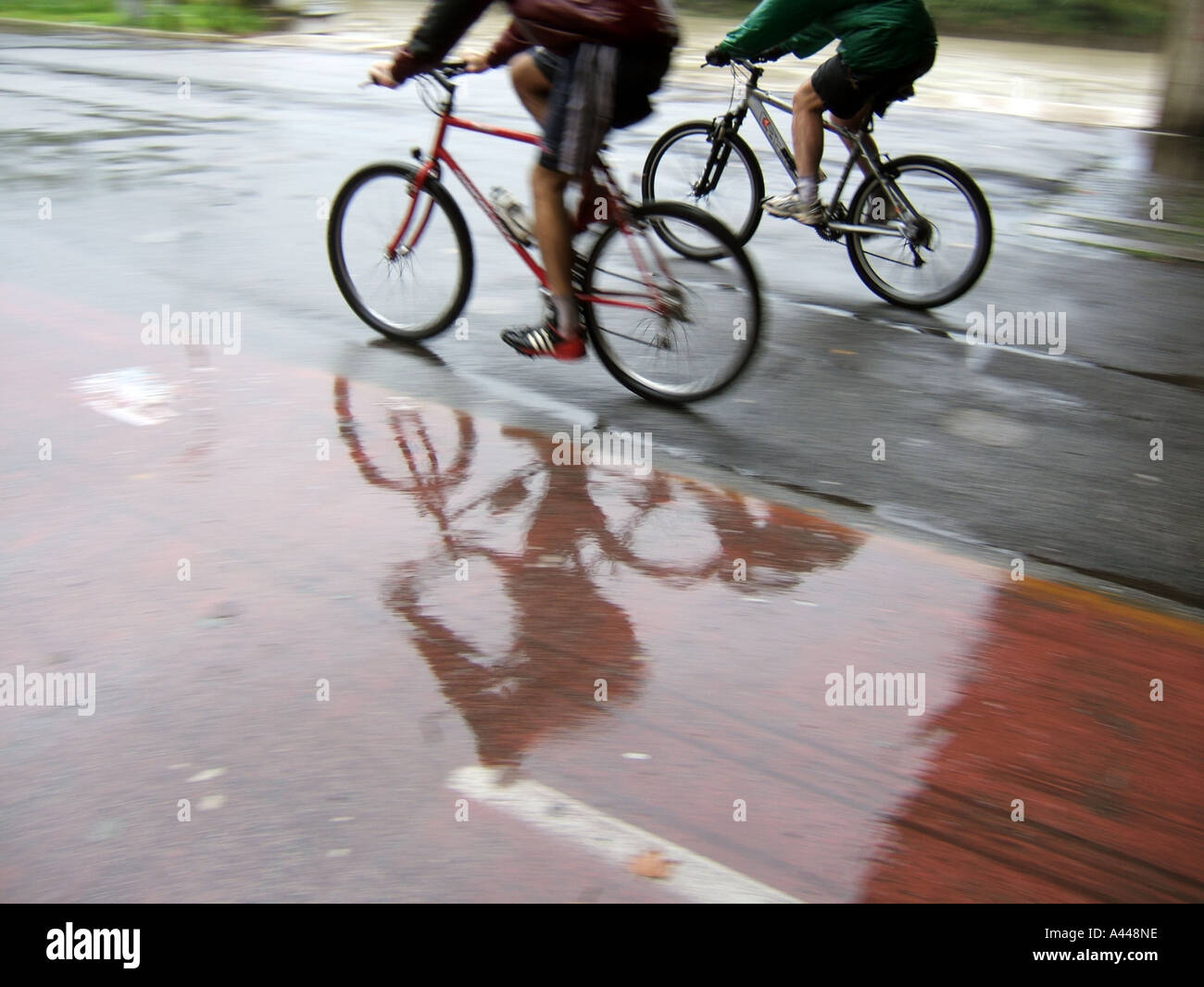 two cyclists in rain Stock Photo Alamy