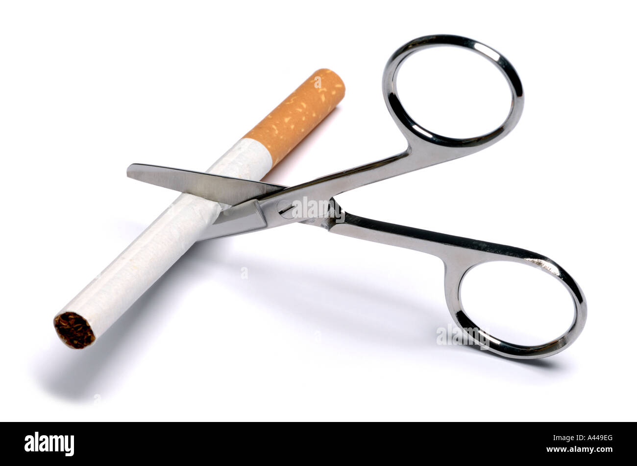 Cigarette being cut in half with scissors Stock Photo
