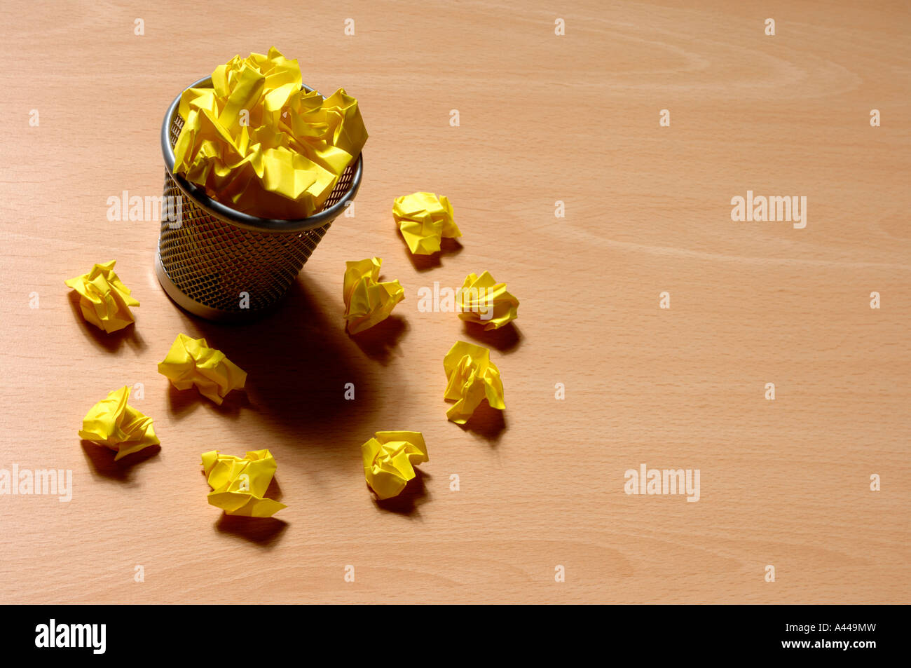 Bin and yellow waste paper Stock Photo Alamy