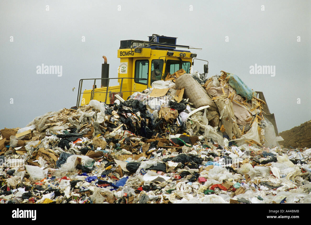 Waste compactor working at landfill site Borough Green Kent Stock Photo