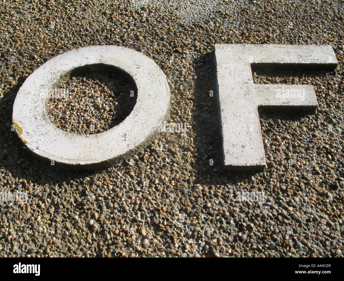 o f  of letters on a pebbledash wall cornwall UK Stock Photo