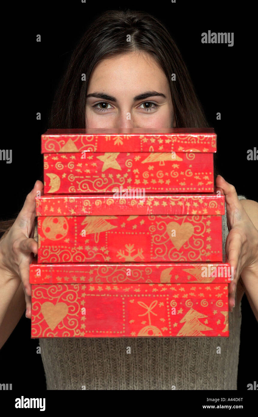 Young woman holding gift boxes smiling portrait Stock Photo - Alamy