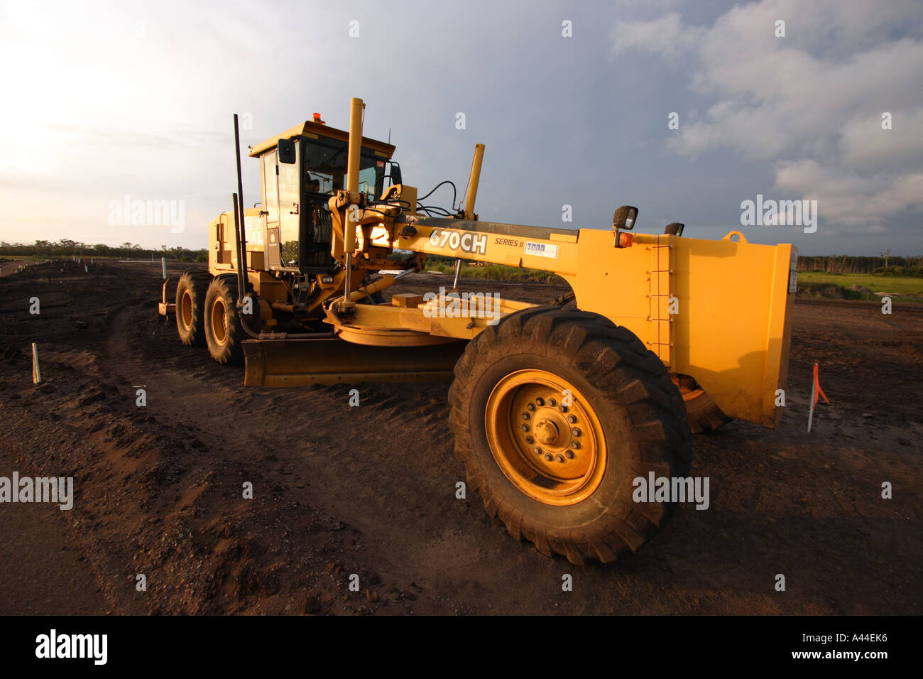 GRADER EXCAVATOR IN AFTERNOON LIGHT / HORIZONTAL Stock Photo Alamy