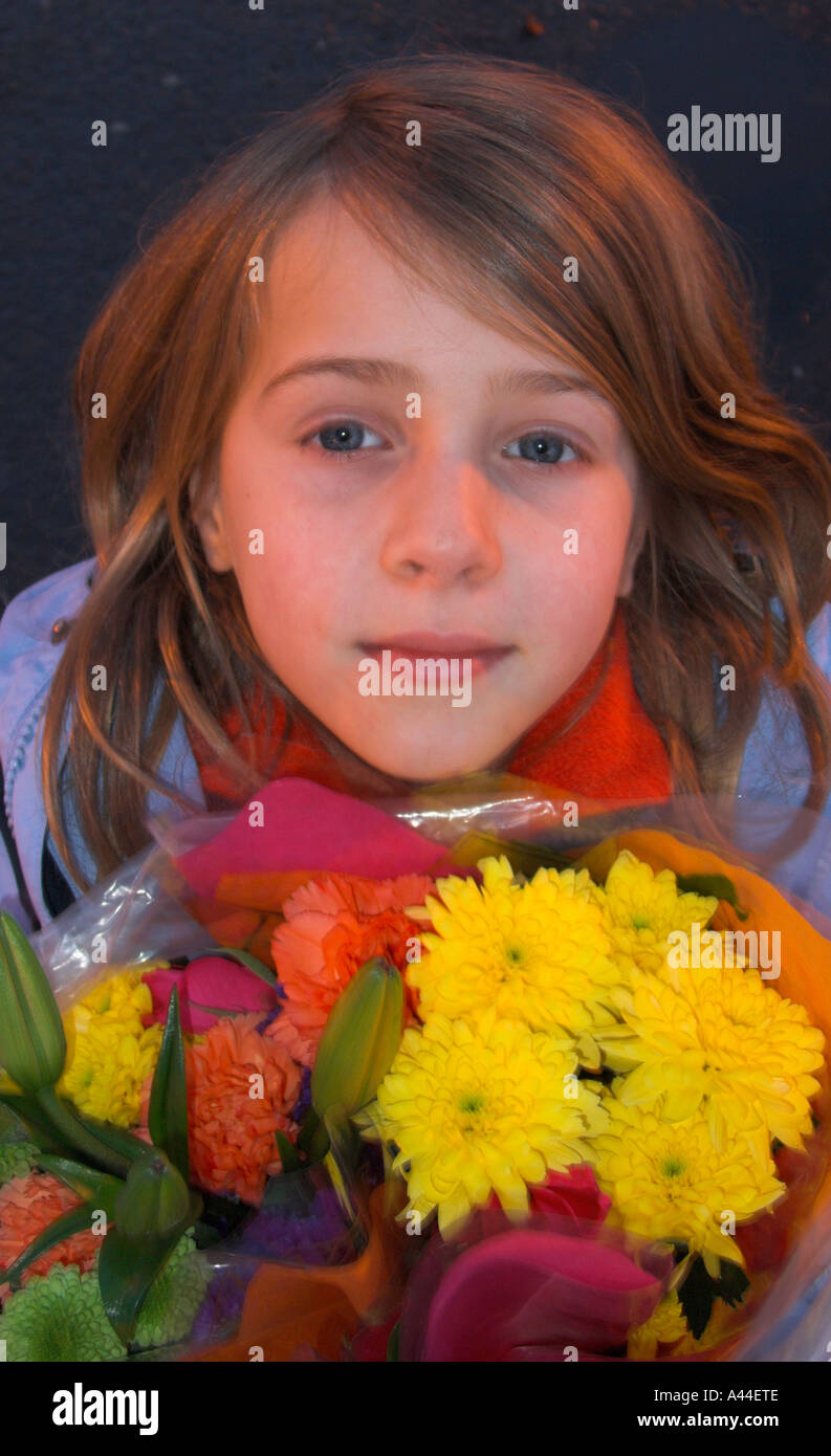young girl smiling cheekily warily Stock Photo