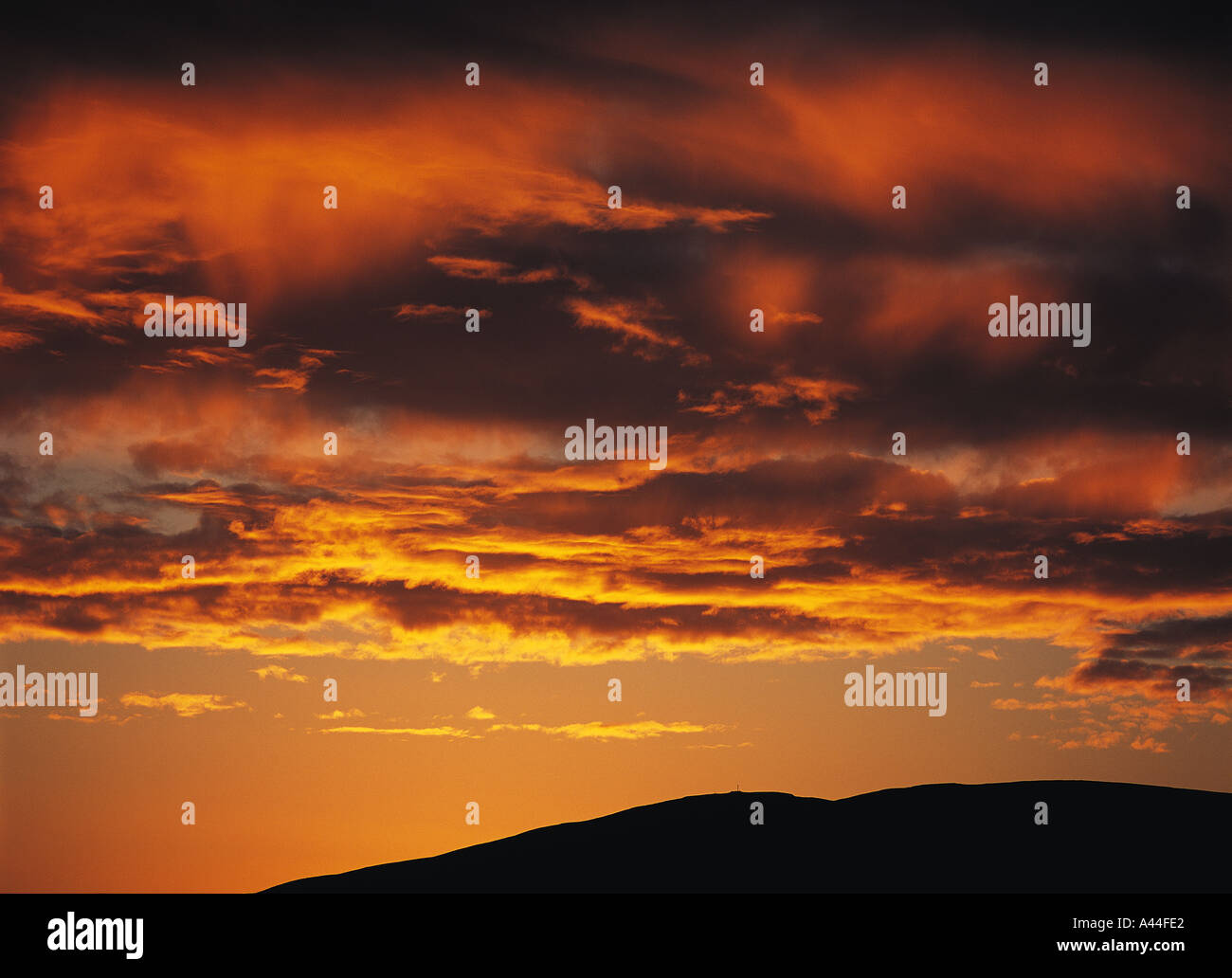 dh SKY WEATHER Orange sunset Orphir Hills Orkney dramatic clouds black background atmospheric Stock Photo