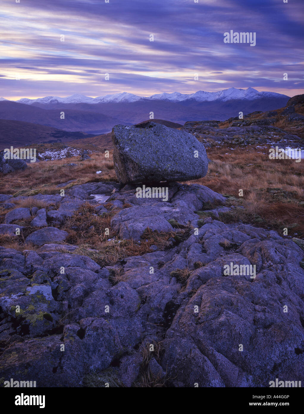 A granite erratic boulder sits high on the hillside overlooking the