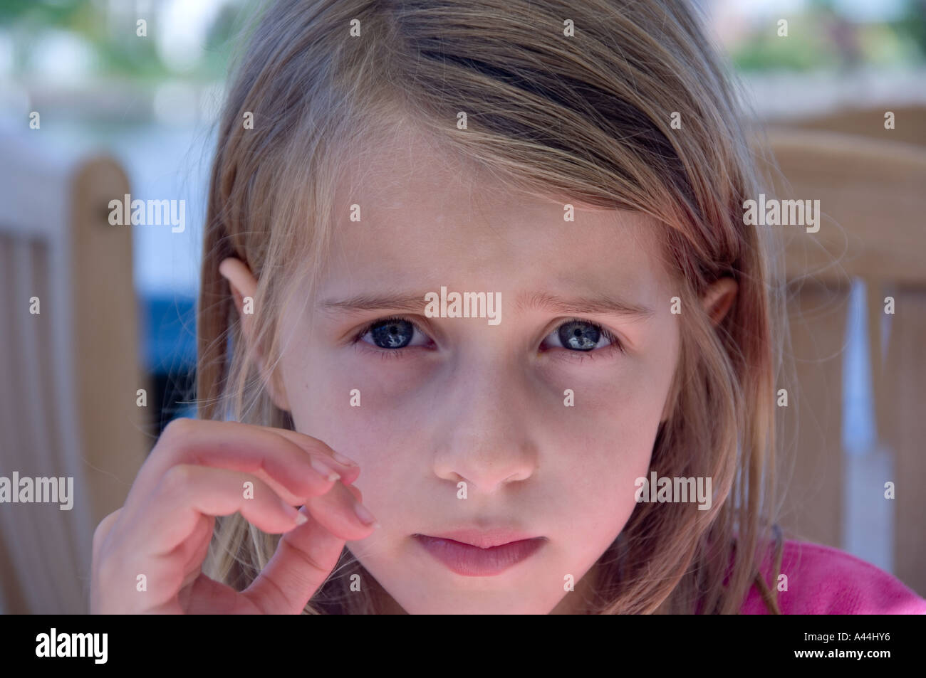 seven year old little girl with anxious eyes Stock Photo