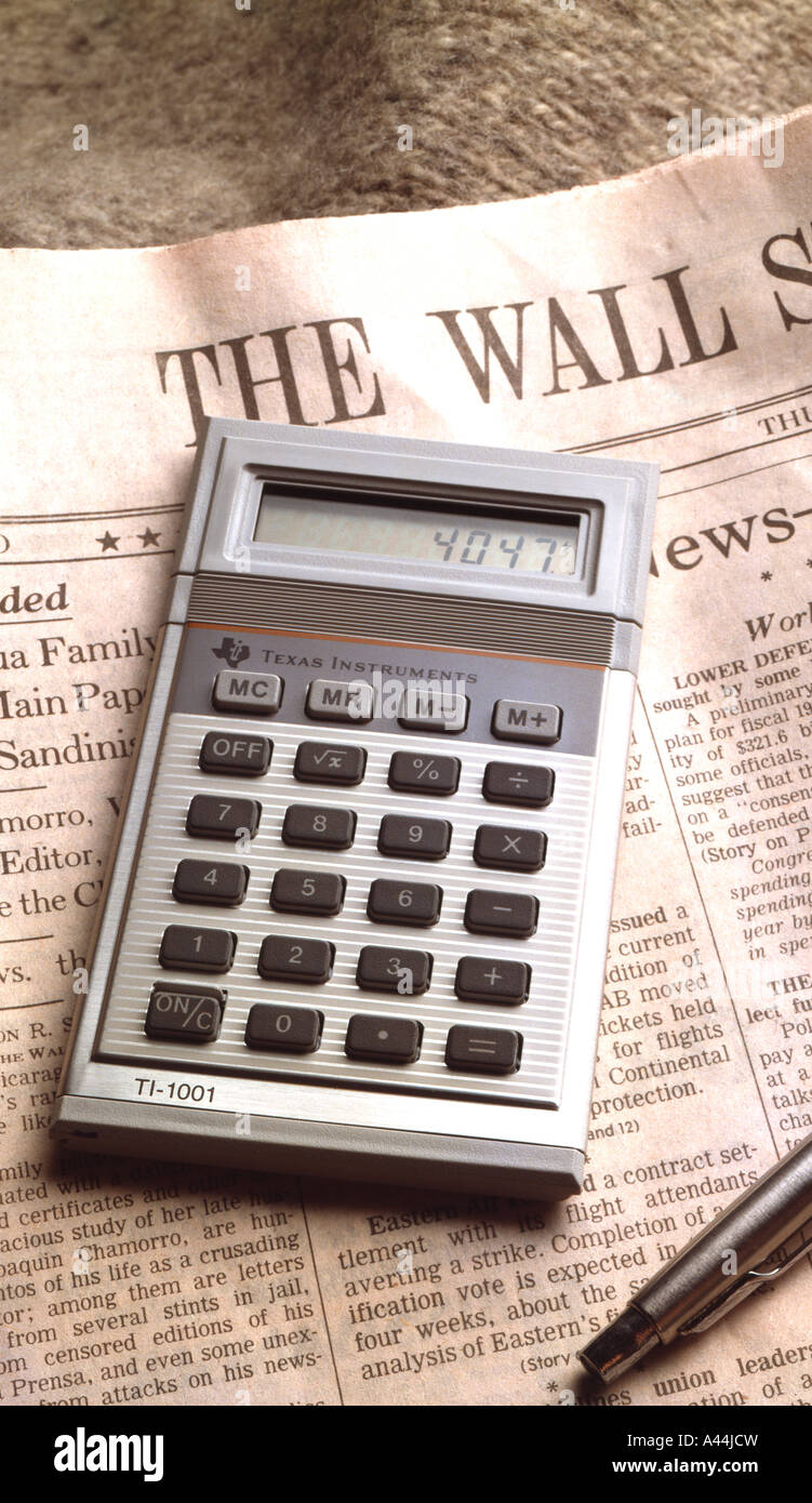 Calculator and investment newspaper, the Wall Street Journal owned by the Dow Jones corporation Stock Photo