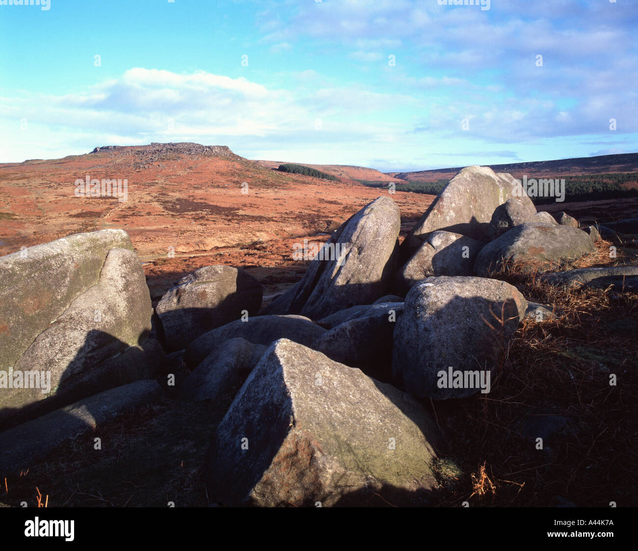 Gritstone boulders at Burbage Rocks, Hathersage Moor, view towards the hillfort of Carl Wark, Peak District National Park Stock Photo