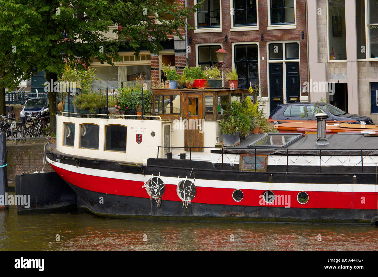 Barge converted into a houseboat moored on the river Amstel. Amsterdam ...