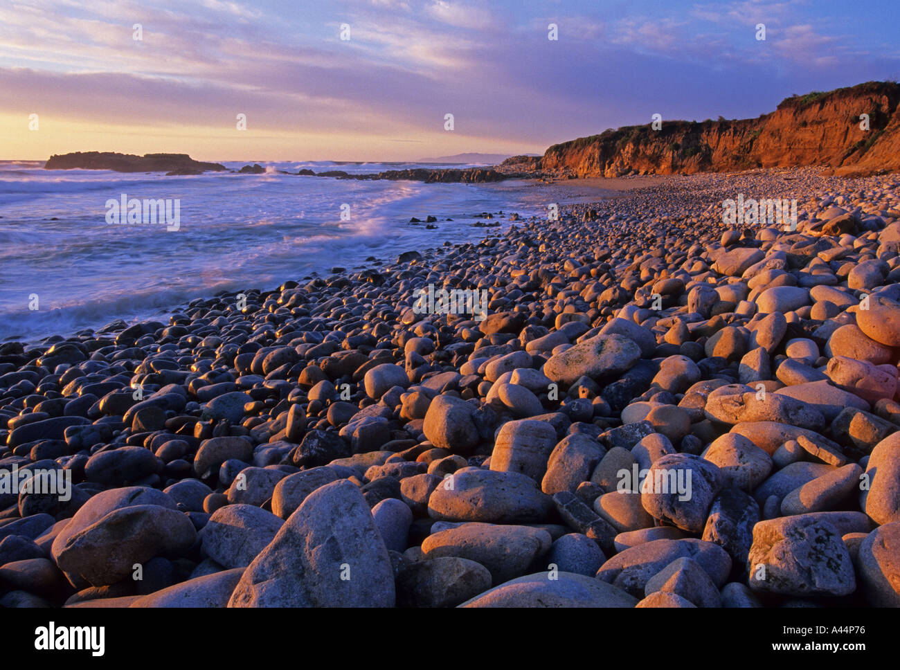 Sunset colors the rocky shoreline of Pescadero State Beach California USA Stock Photo