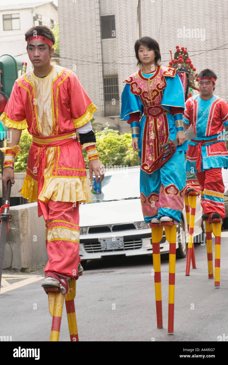 Chinese Teenagers Dressed In Taoist Warrior Costumes Walking On Stilts In Religious Procession Taipei Taiwan China Stock Photo