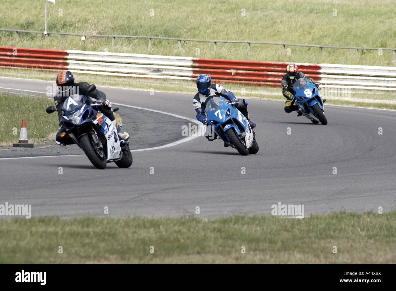 three motorbikes racing track day speed race Stock Photo