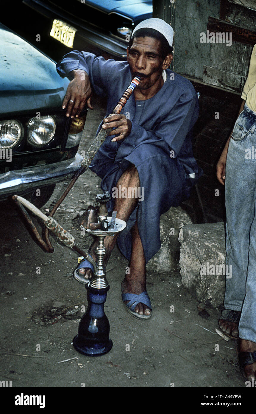 Smoking his shisha in a busy street in Luxor, Egypt Stock Photo