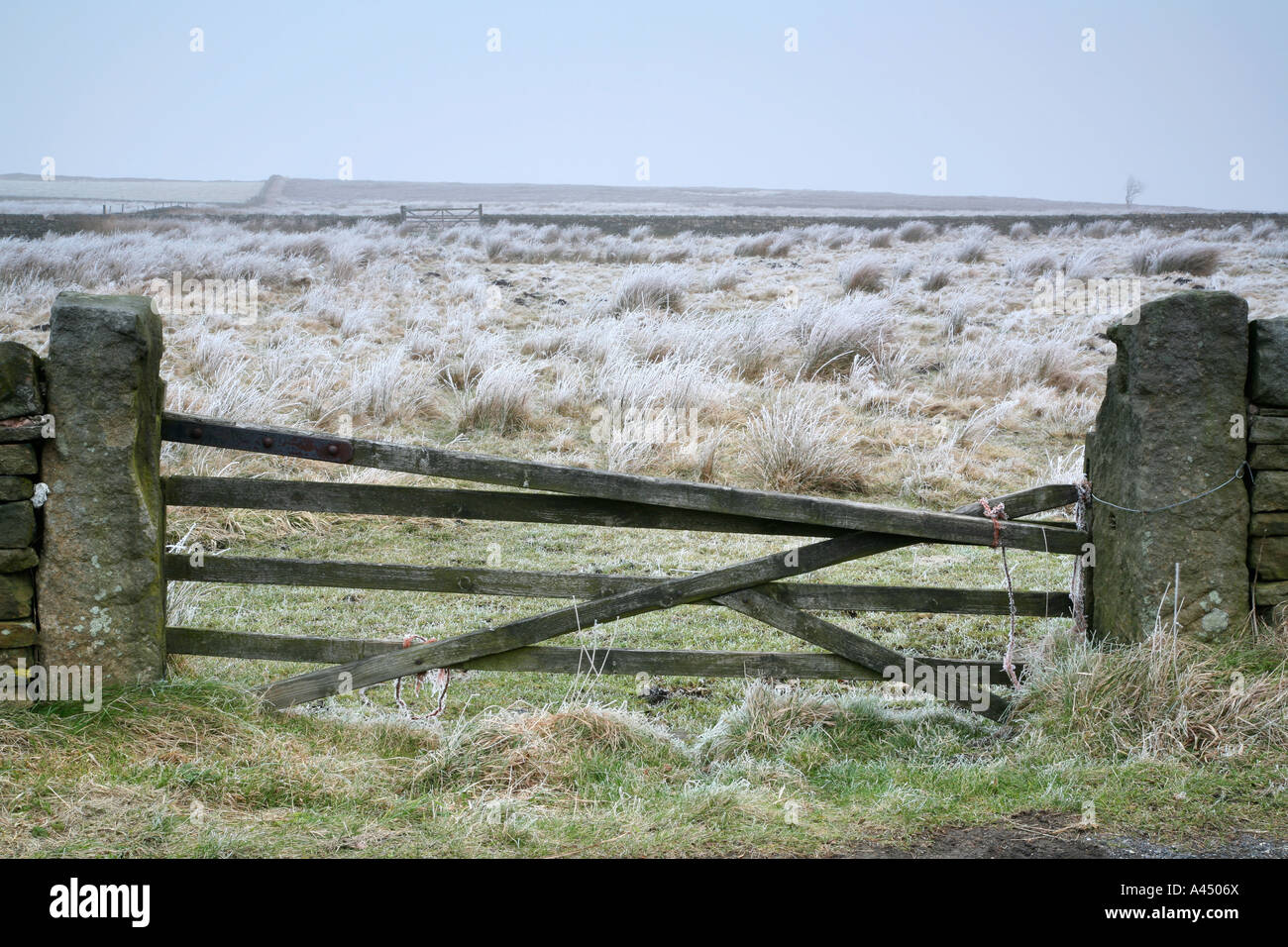Broken gate and a frosty field near Redmires Reservoir in Sheffield. On the boundary of the Peak District National Park Stock Photo