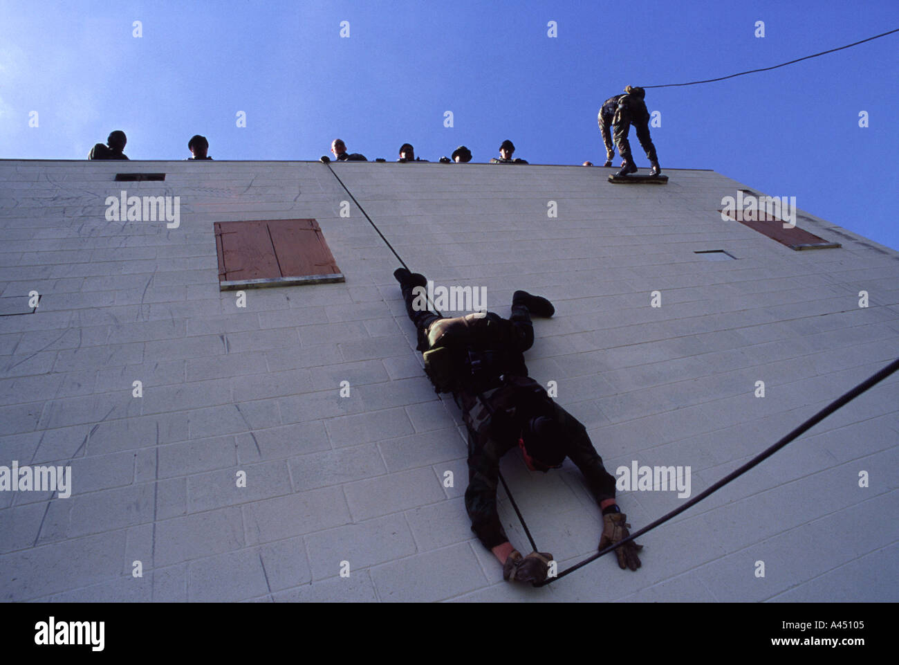 SORT officers rappelling down a wall. SORT is the SWAT of prisons
