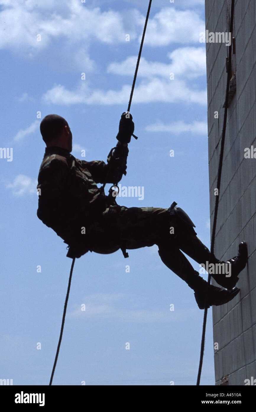 SORT officer rappelling down a wall. SORT is the SWAT of prisons Stock